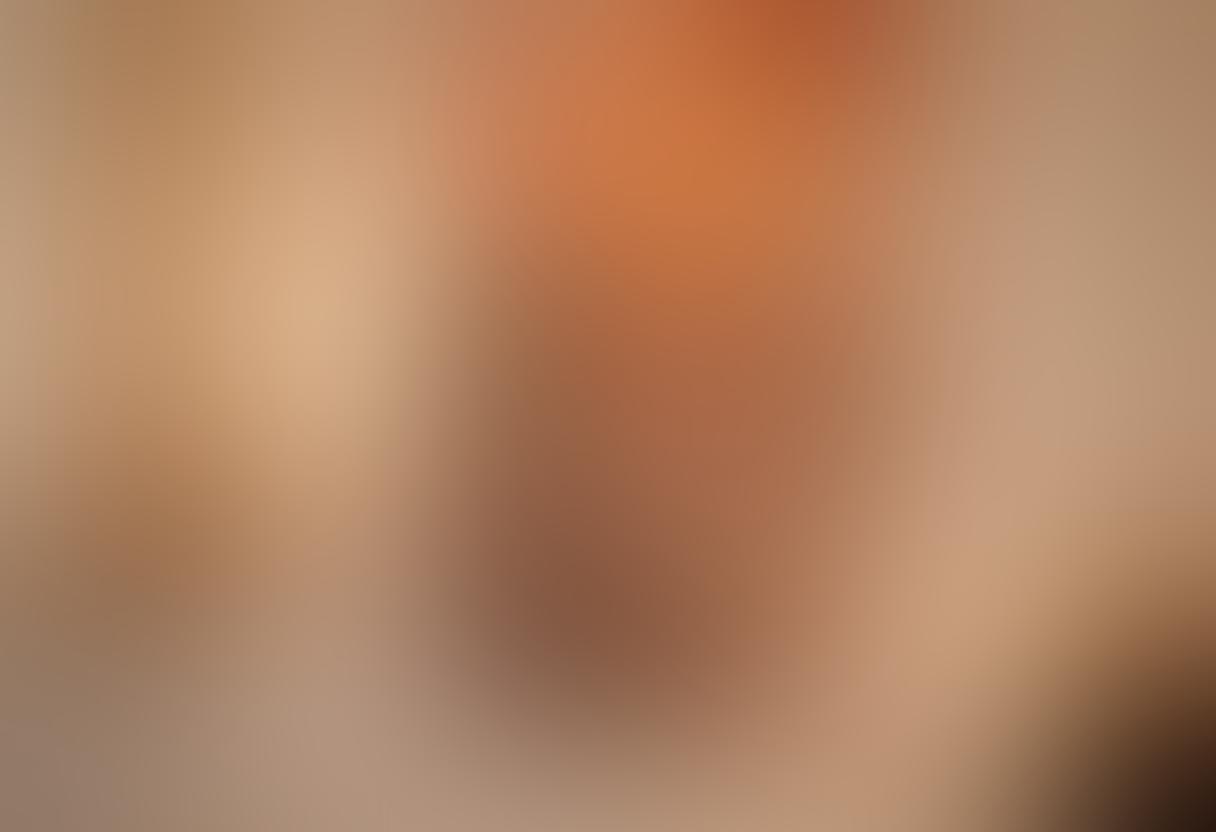 A serene and intimate setting where a diverse couple engages in art therapy, surrounded by evocative erotic art pieces that inspire connection and empowerment. The warm lighting enhances the emotional atmosphere, while soft textures and calming colors create a safe space. Various art supplies are scattered, inviting creativity and open dialogue. The couple appears engaged and connected, symbolizing healing and intimacy. soft focus. warm tones. painting.